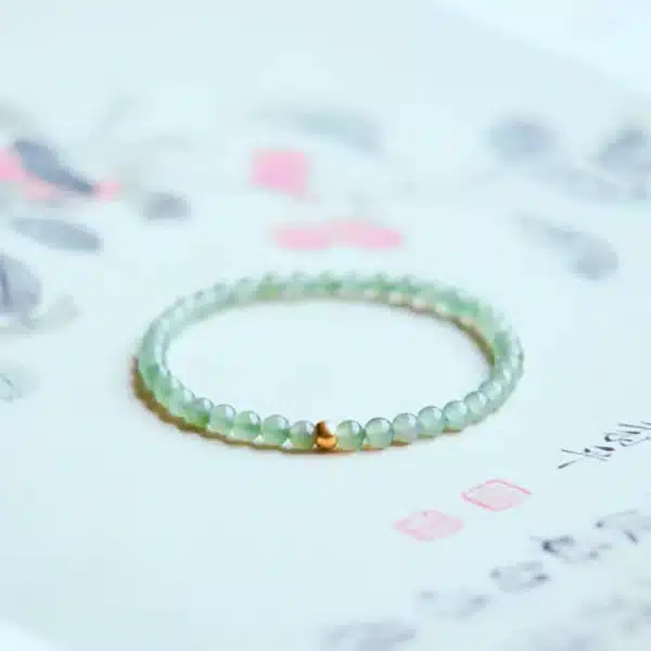 an amage of Elegant Hetian Jade Bracelet with Gold Lucky Beads